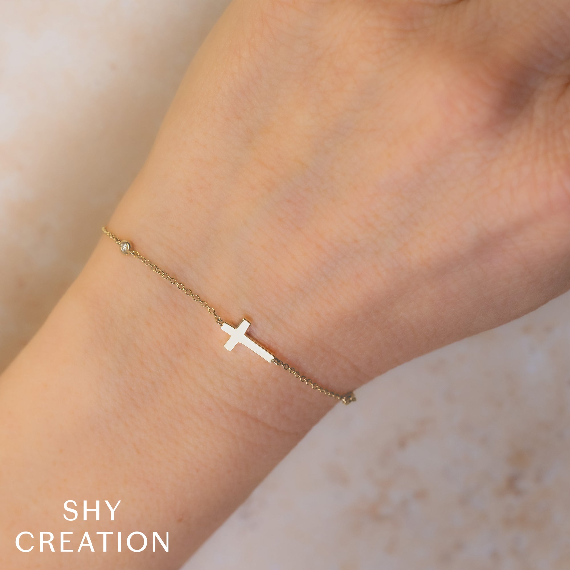 0.03CT 14K Y/G DIAMOND BEZEL CROSS BRACELET